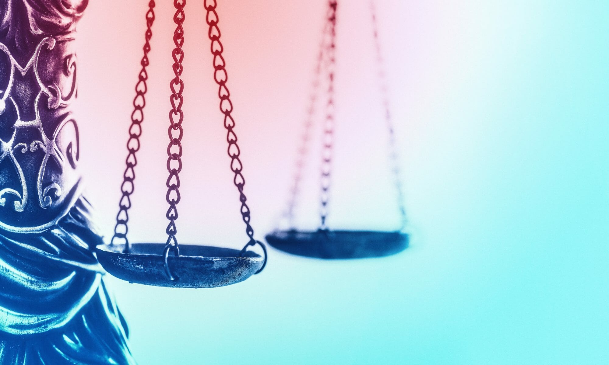 Photo of Justice scales with pink to blue gradient background