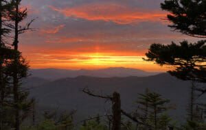 A waning sunset from a mountaintop, sky aglow in orange